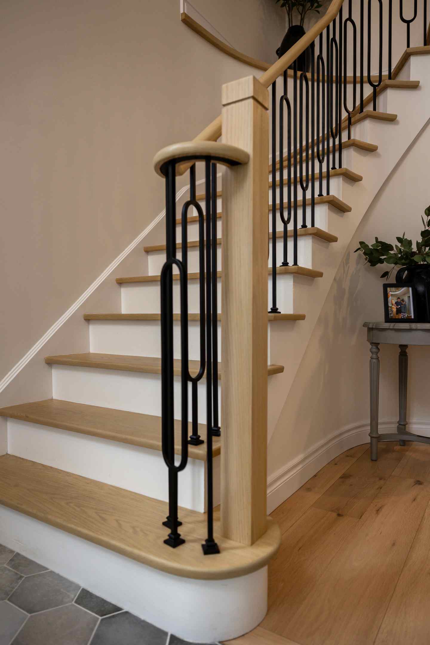 Stained stair treads and railing with black metal pickets