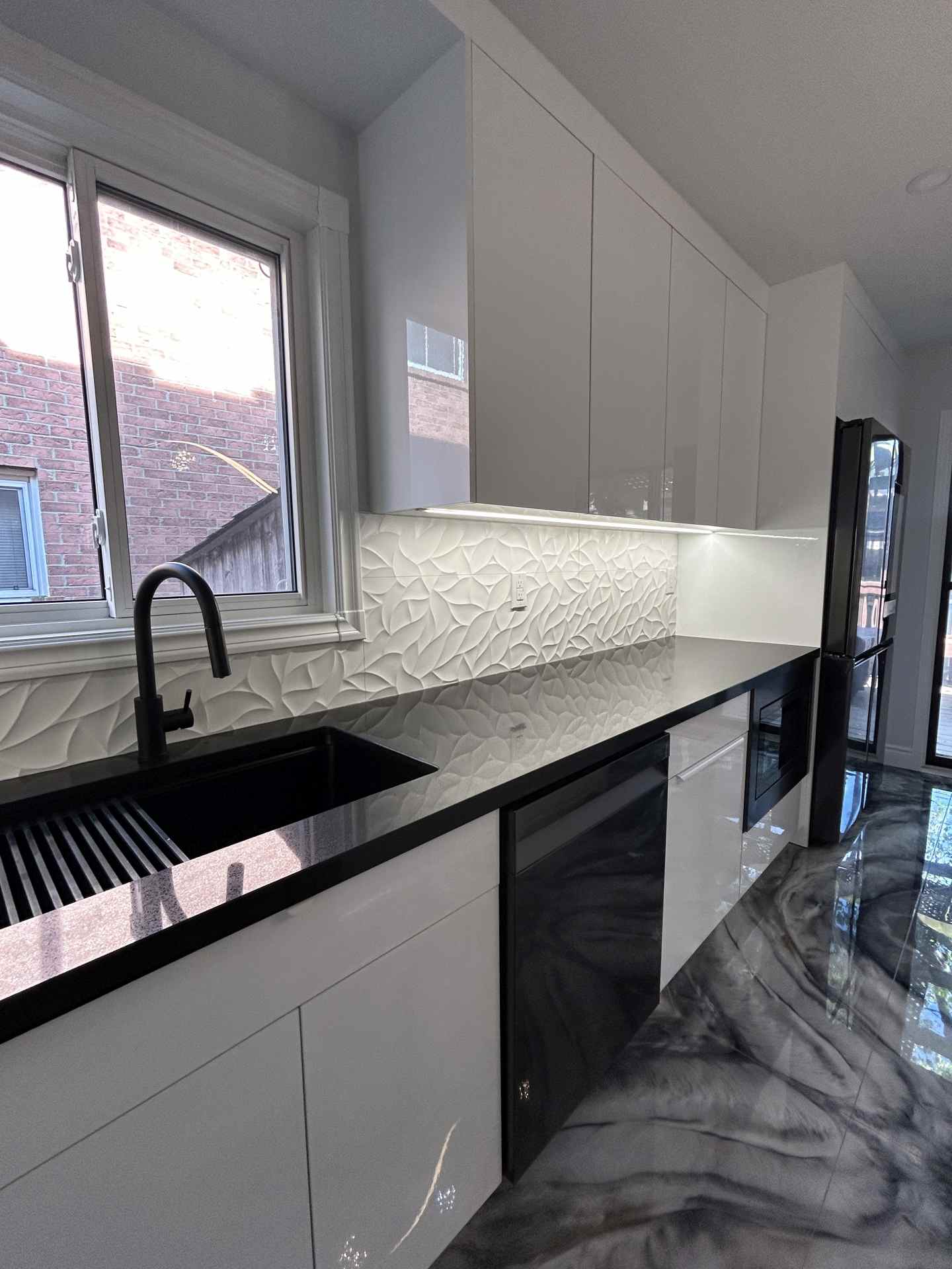 Modern Ajax kitchen with white high gloss cabinets and black countertop