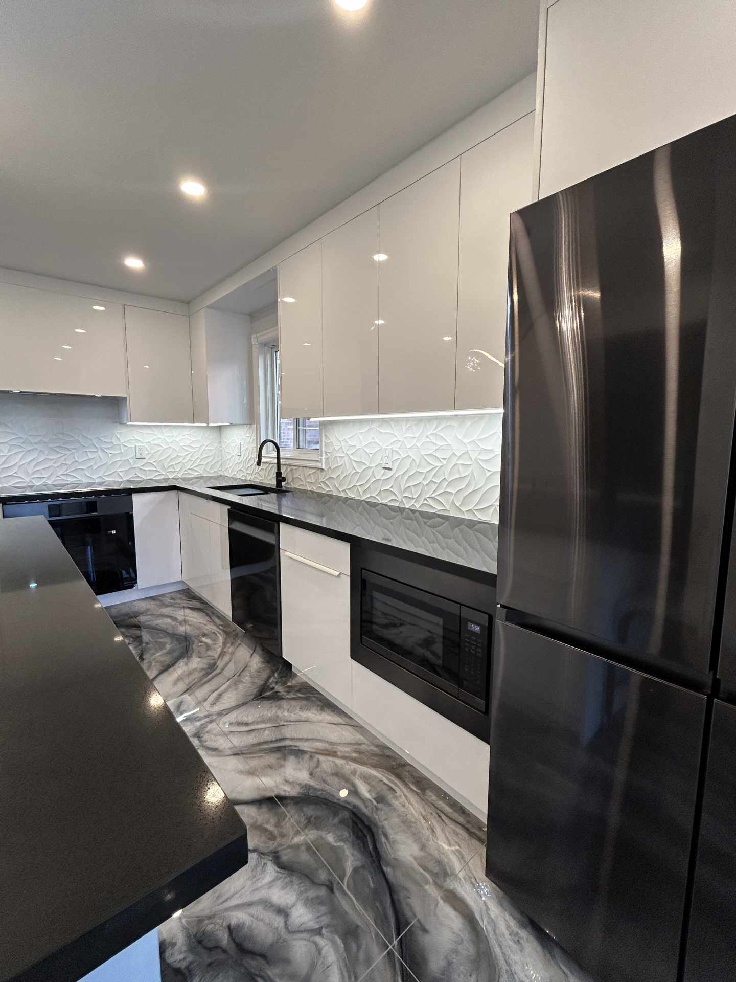Custom high gloss kitchen cabinetry with tall upper cabinets