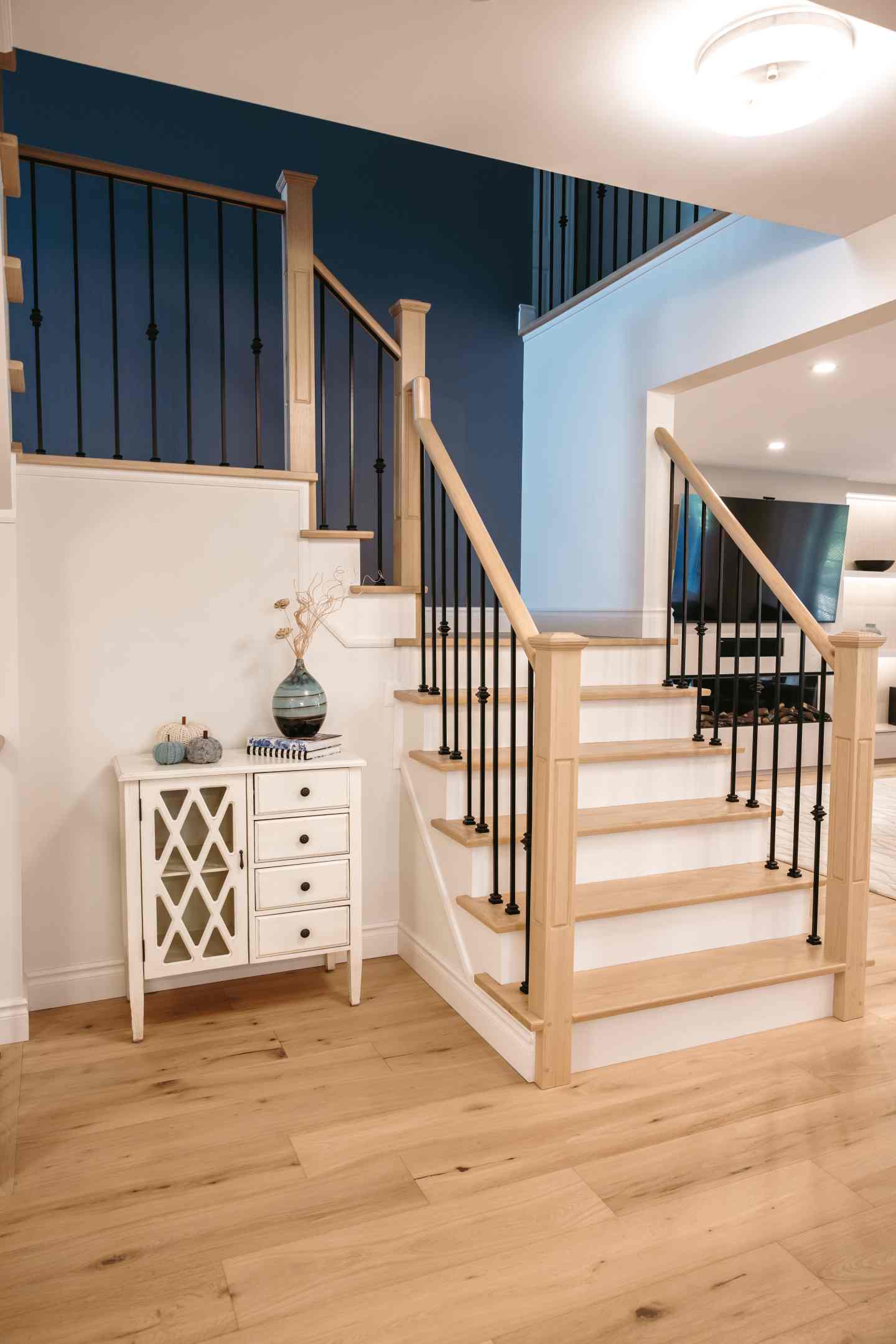 Stained stair treads matching engineered hardwood flooring in Whitby home
