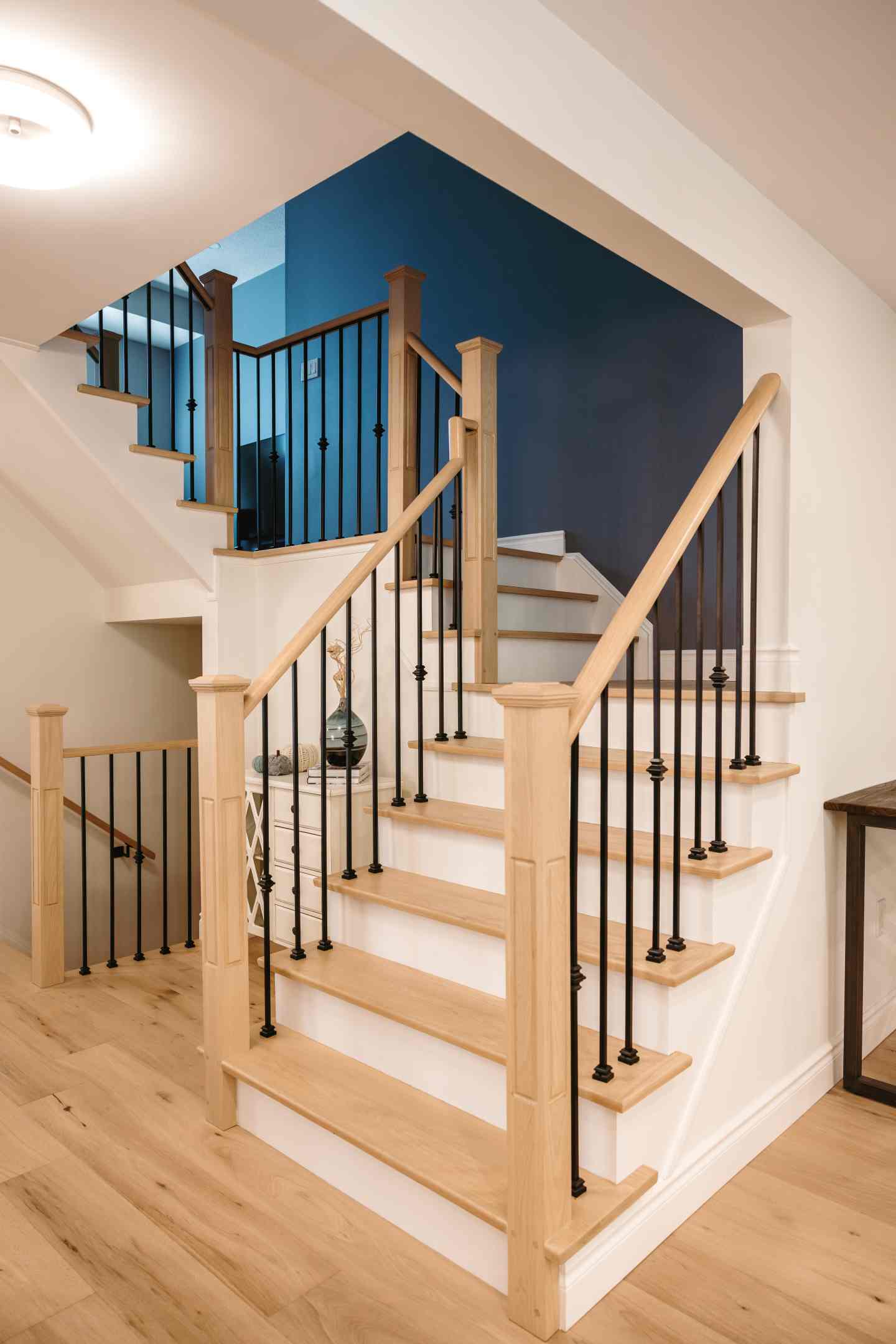 Stained stair treads matching engineered hardwood flooring in Whitby home