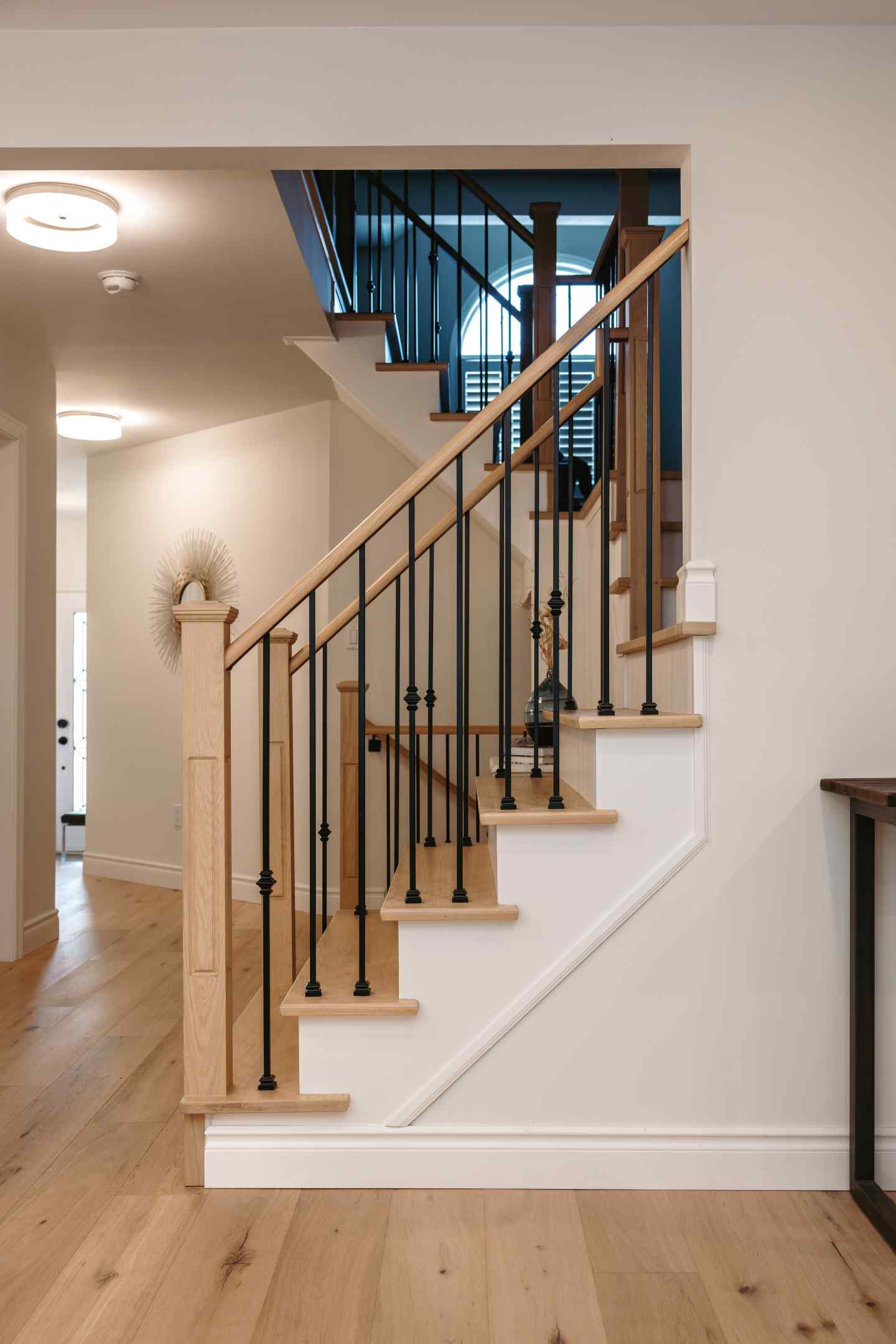 Stained stair treads matching engineered hardwood flooring in Whitby home